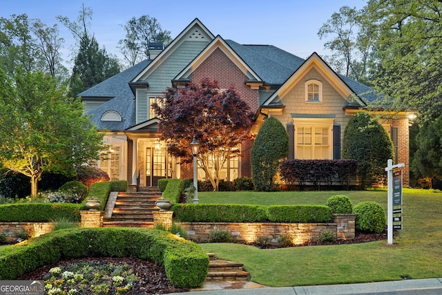 craftsman-style home with a front yard