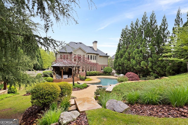 back of property featuring a patio and a pool side deck