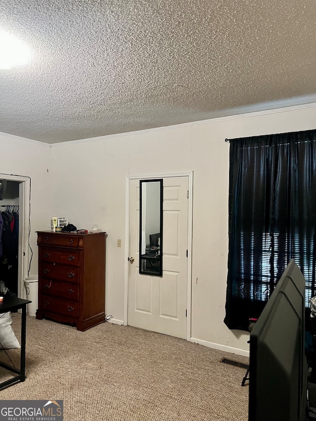 bedroom with light carpet, a closet, and a textured ceiling