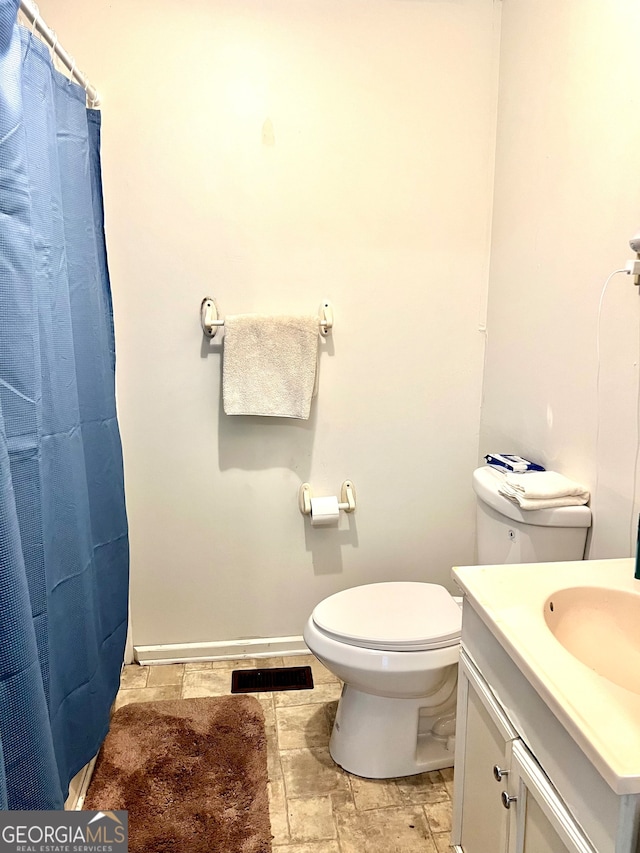 bathroom featuring vanity, a shower with curtain, and toilet