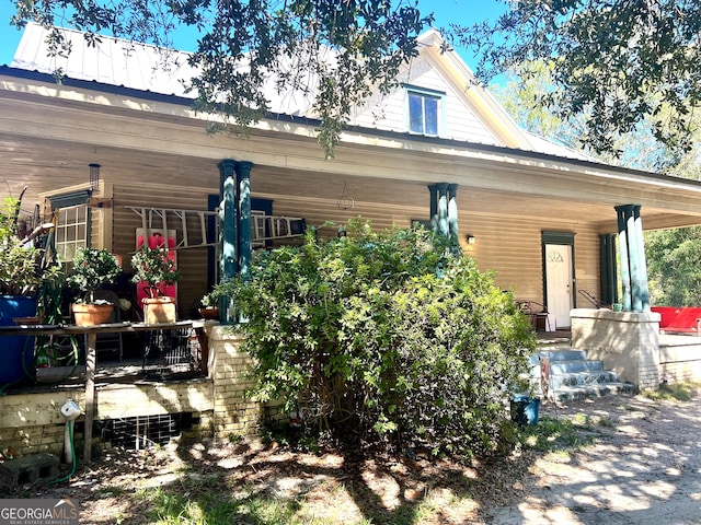 back of property with a porch