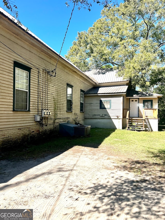 view of side of property with central air condition unit