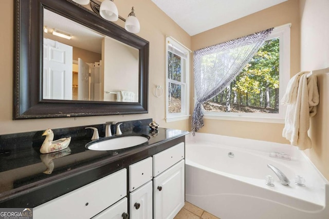 bathroom with vanity, tile patterned flooring, and a bathing tub