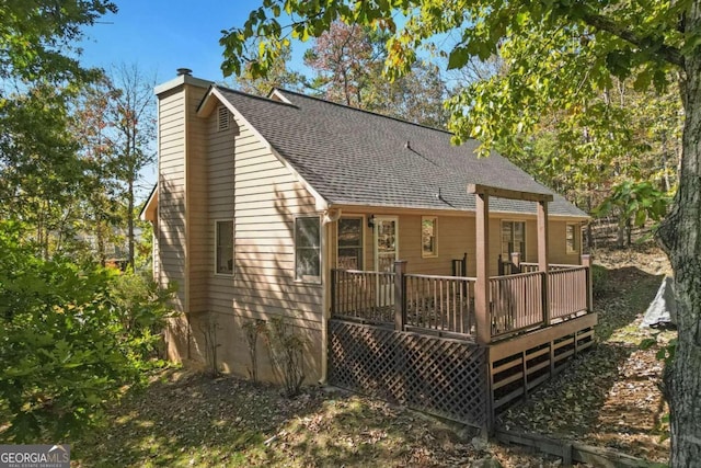 rear view of property featuring a deck