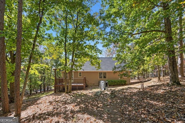 rear view of property with a wooden deck