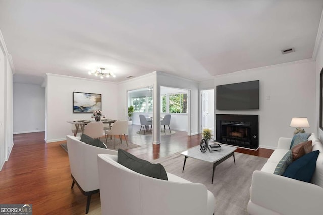 living room with ornamental molding and hardwood / wood-style floors