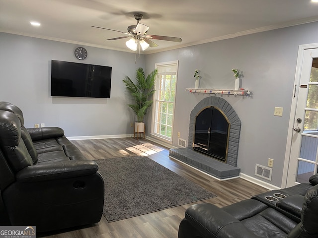 living room featuring dark hardwood / wood-style flooring, ceiling fan, and crown molding