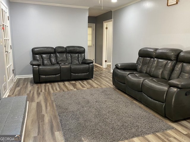 home theater room with hardwood / wood-style floors and crown molding