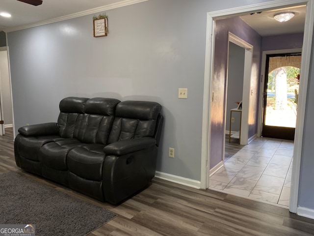 interior space with ornamental molding, hardwood / wood-style floors, and ceiling fan