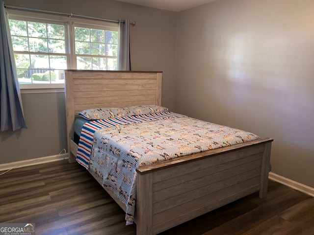 bedroom featuring dark wood-type flooring and multiple windows