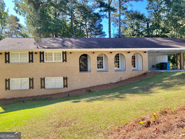 single story home featuring a carport and a front yard