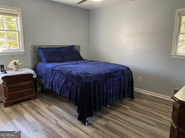 bedroom with hardwood / wood-style floors and ceiling fan