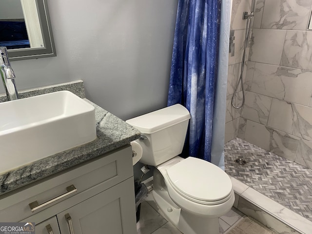 bathroom with walk in shower, vanity, and toilet