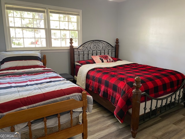 bedroom with hardwood / wood-style flooring