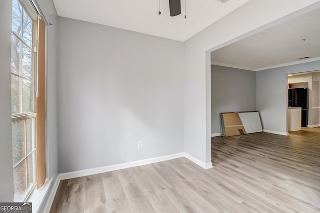 unfurnished room featuring light hardwood / wood-style floors, crown molding, and ceiling fan