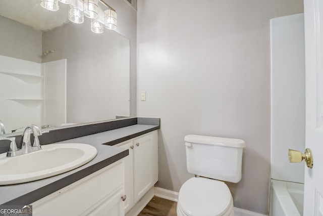 full bathroom with vanity, toilet, wood-type flooring, and  shower combination