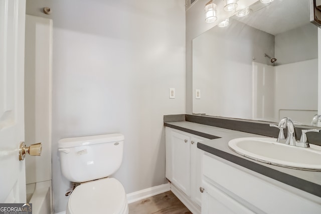 full bathroom featuring vanity, hardwood / wood-style floors, toilet, and tub / shower combination