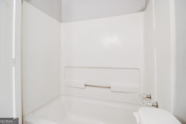 bathroom with toilet and shower / bath combination