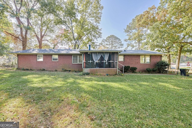 back of property featuring a yard and a sunroom