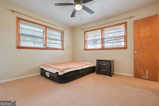 bedroom featuring ceiling fan and light colored carpet