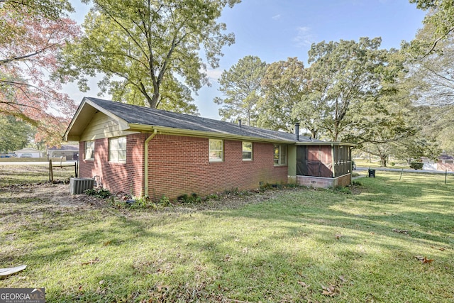 view of home's exterior featuring a yard and a sunroom