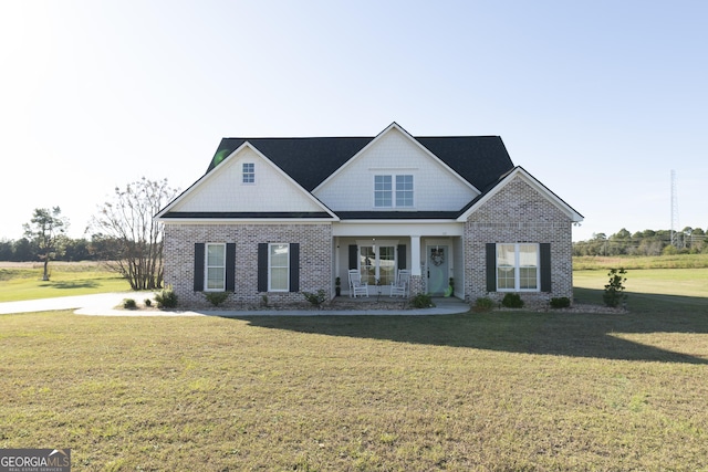 craftsman inspired home featuring a porch and a front lawn