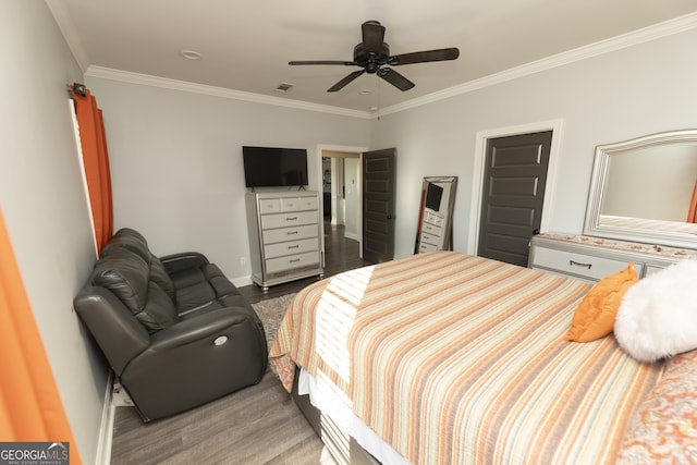 bedroom featuring ceiling fan, wood-type flooring, and ornamental molding