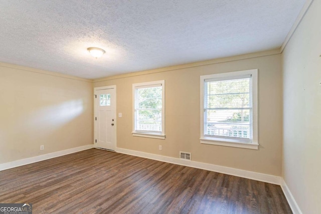 entryway featuring crown molding, a textured ceiling, and dark hardwood / wood-style floors