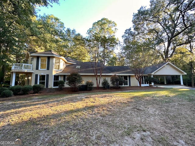 view of front of house with central AC and a carport