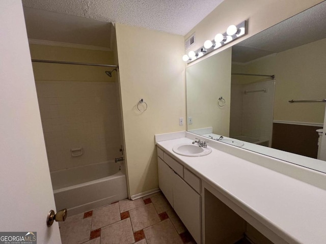 bathroom with tiled shower / bath, vanity, a textured ceiling, and tile patterned floors