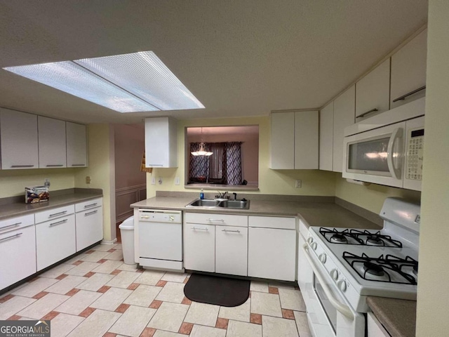 kitchen with a notable chandelier, white cabinetry, sink, and white appliances