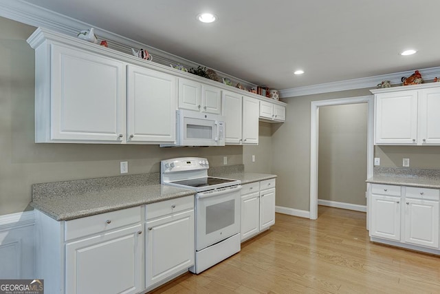 kitchen with white cabinets, light countertops, ornamental molding, white appliances, and light wood-type flooring