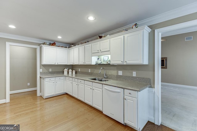 kitchen featuring dishwasher, crown molding, white cabinetry, and a sink