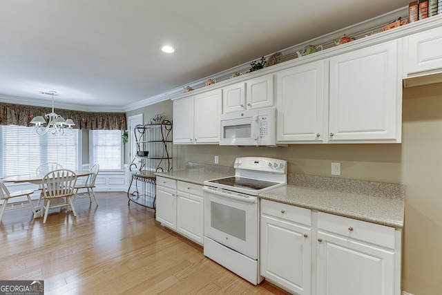 kitchen featuring white appliances, a chandelier, crown molding, white cabinets, and light wood-type flooring