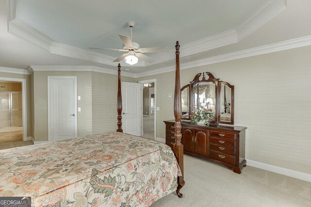 bedroom featuring light colored carpet, baseboards, a raised ceiling, and crown molding