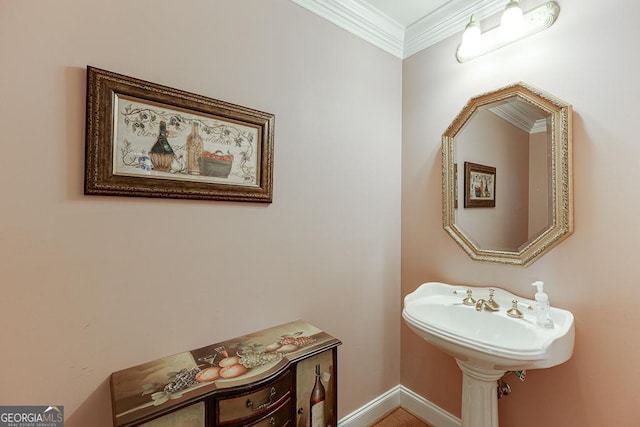 bathroom featuring crown molding and baseboards