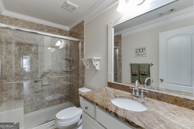 bathroom featuring a shower with shower door, vanity, toilet, and crown molding