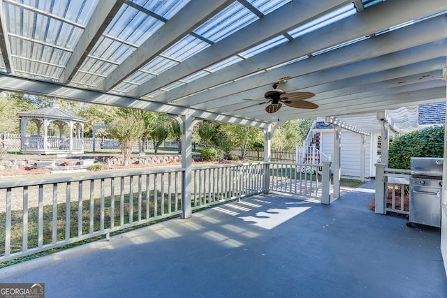 view of patio with ceiling fan, a pergola, a gazebo, and grilling area