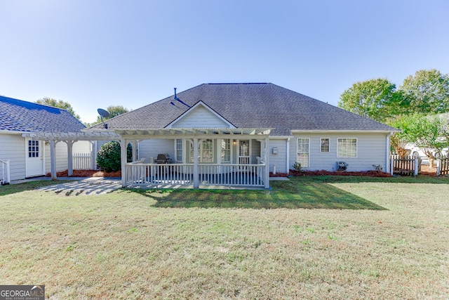 view of front of property with a front lawn, a pergola, and a patio