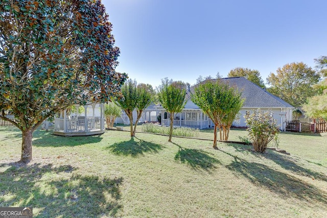 view of yard featuring fence and a deck