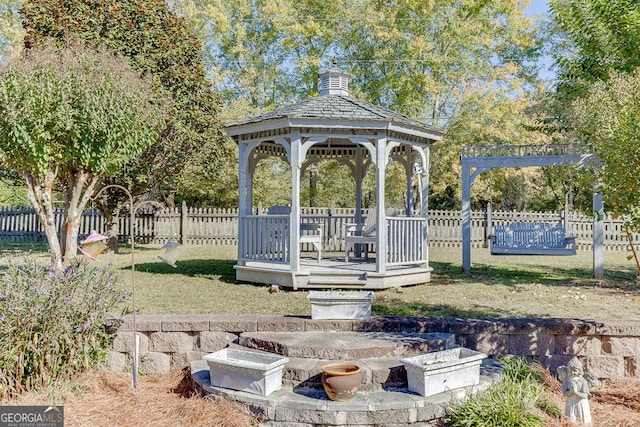 view of community featuring fence and a gazebo