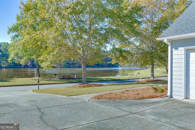 view of home's community featuring a water view and a yard