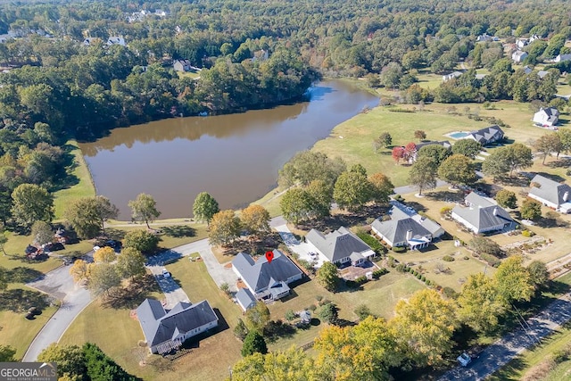aerial view featuring a view of trees and a water view