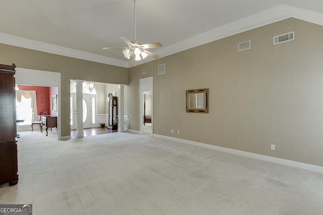 interior space featuring light colored carpet, ceiling fan, crown molding, and visible vents