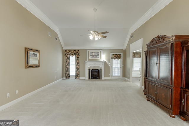 unfurnished living room featuring ceiling fan, light carpet, vaulted ceiling, and ornamental molding