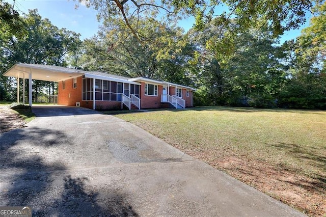 ranch-style home with a front yard and a carport