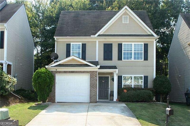 view of front of home with a garage and a front lawn