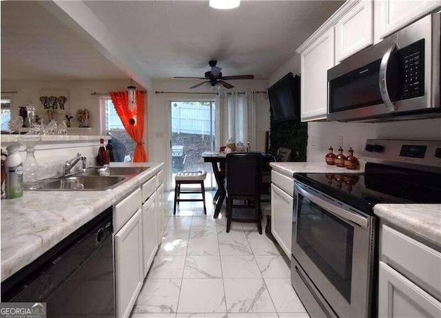 kitchen with white cabinetry, ceiling fan, appliances with stainless steel finishes, and sink