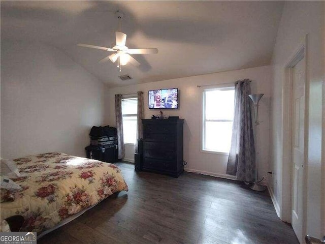 bedroom with dark hardwood / wood-style flooring, lofted ceiling, and ceiling fan