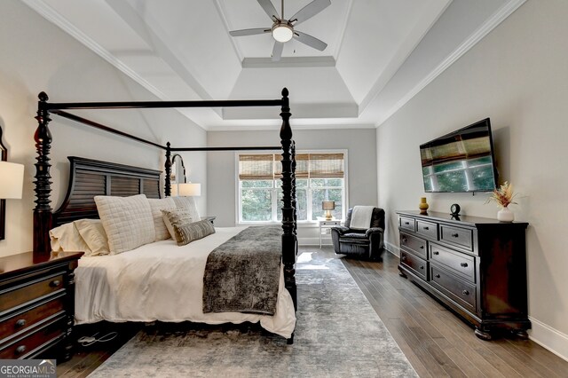 bedroom featuring crown molding, hardwood / wood-style flooring, a raised ceiling, and ceiling fan